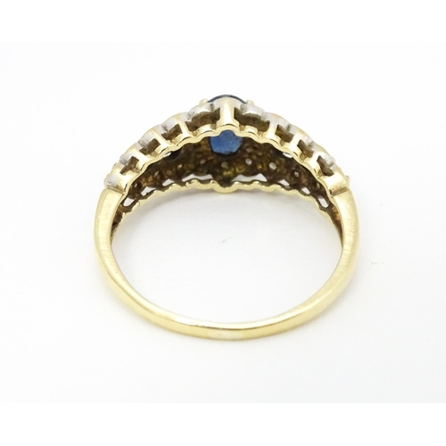 577 - A 9ct gold ring set with sapphires and diamonds. Ring size approx. P