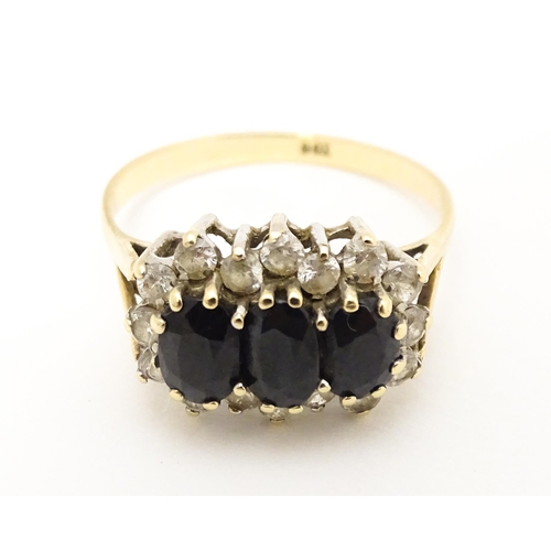 582 - A 9ct gold ring set with blue and white stones. Ring size approx. S