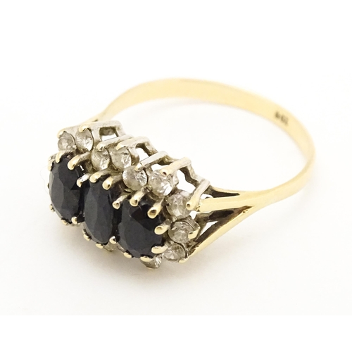 582 - A 9ct gold ring set with blue and white stones. Ring size approx. S