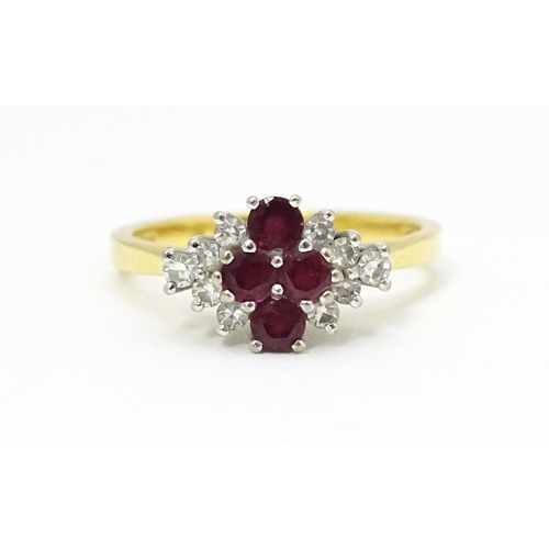 593 - An 18ct gold ring set with four rubies bordered by diamonds. Ring size approx. M