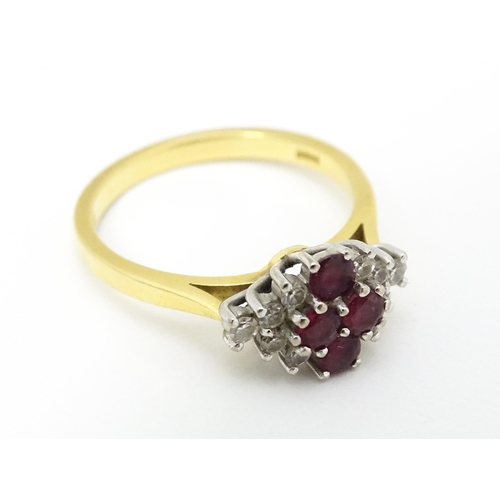 593 - An 18ct gold ring set with four rubies bordered by diamonds. Ring size approx. M