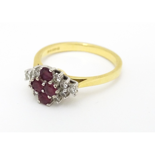 593 - An 18ct gold ring set with four rubies bordered by diamonds. Ring size approx. M