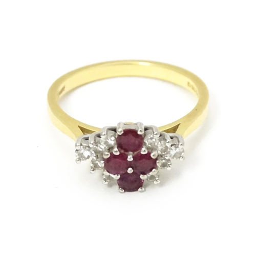 593 - An 18ct gold ring set with four rubies bordered by diamonds. Ring size approx. M