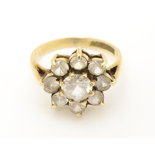 602 - A 9ct gold ring set with white stones. Ring size approx N.