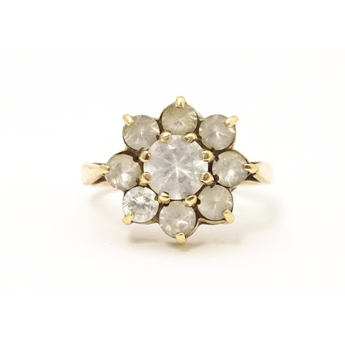 602 - A 9ct gold ring set with white stones. Ring size approx N.