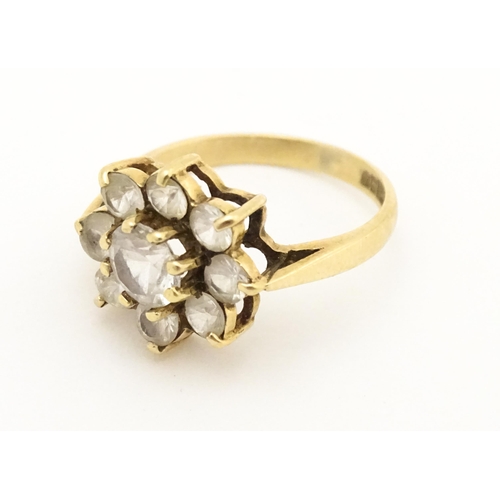 602 - A 9ct gold ring set with white stones. Ring size approx N.