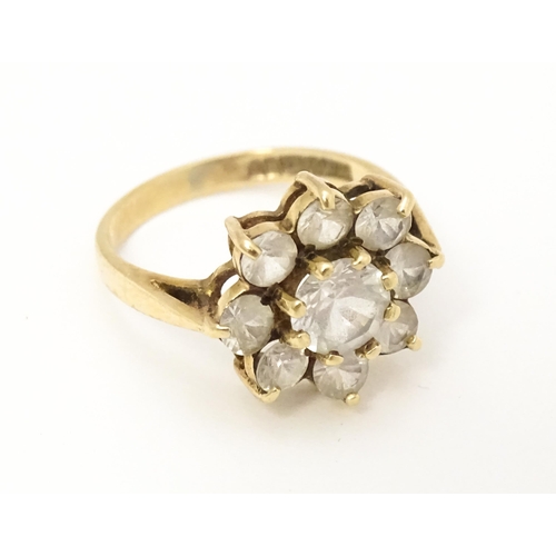 602 - A 9ct gold ring set with white stones. Ring size approx N.