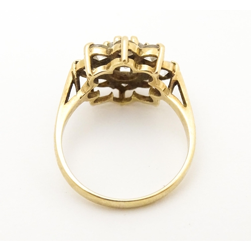 602 - A 9ct gold ring set with white stones. Ring size approx N.