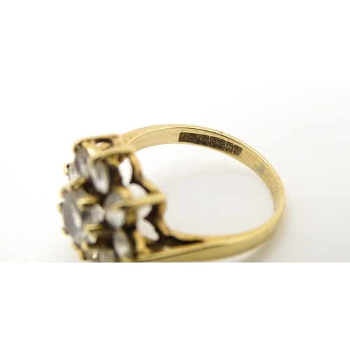 602 - A 9ct gold ring set with white stones. Ring size approx N.