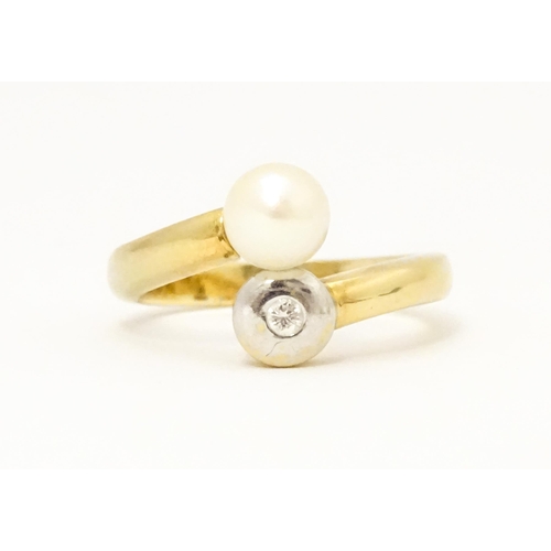 607 - An 18ct gold ring set with diamond and pearl Ring size approx. L 1/2