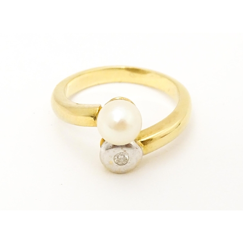 607 - An 18ct gold ring set with diamond and pearl Ring size approx. L 1/2