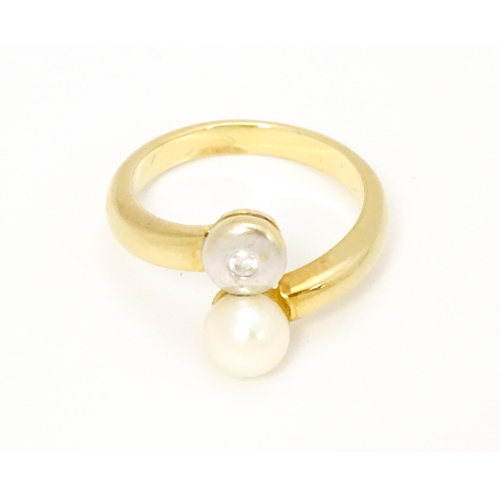 607 - An 18ct gold ring set with diamond and pearl Ring size approx. L 1/2