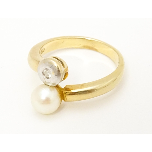 607 - An 18ct gold ring set with diamond and pearl Ring size approx. L 1/2