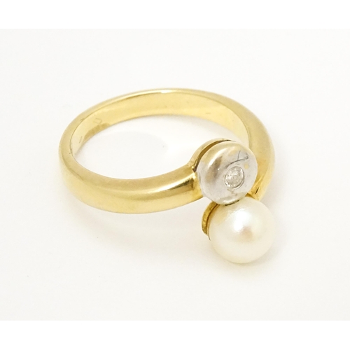 607 - An 18ct gold ring set with diamond and pearl Ring size approx. L 1/2