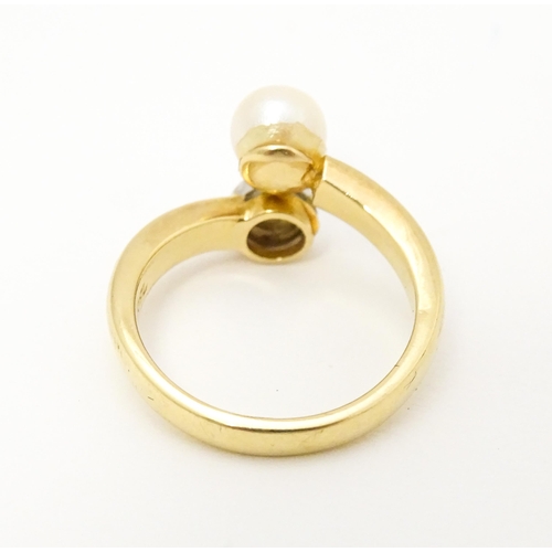 607 - An 18ct gold ring set with diamond and pearl Ring size approx. L 1/2