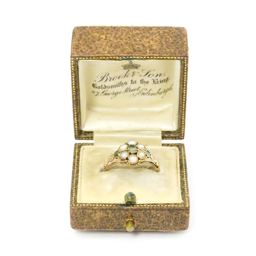 619 - A Victorian gold ring set with emeralds and pearls. Ring size approx. O