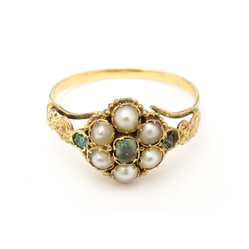 619 - A Victorian gold ring set with emeralds and pearls. Ring size approx. O