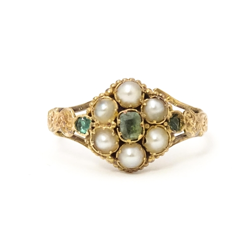 619 - A Victorian gold ring set with emeralds and pearls. Ring size approx. O