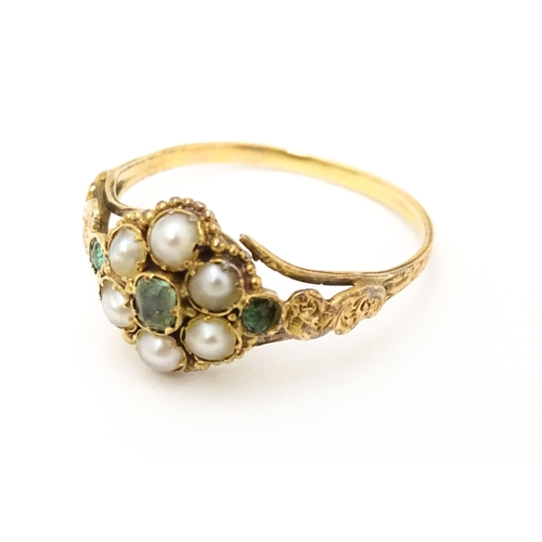 619 - A Victorian gold ring set with emeralds and pearls. Ring size approx. O