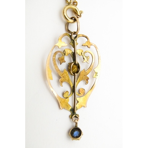 627 - A 9ct gold Art Nouveau pendant with blue detail, with a 9ct gold chain. Pendant approx. 1 1/2