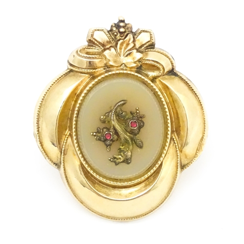 630 - A Victorian yellow metal brooch with foliate and bow detail. Approx. 1 1/2