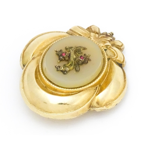 630 - A Victorian yellow metal brooch with foliate and bow detail. Approx. 1 1/2