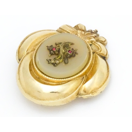 630 - A Victorian yellow metal brooch with foliate and bow detail. Approx. 1 1/2