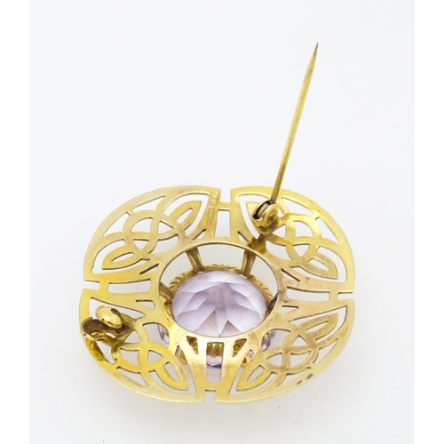 634 - A 9ct gold brooch set with central amethyst with Celtic decoration, hallmarked Birmingham 1966, 
mak... 