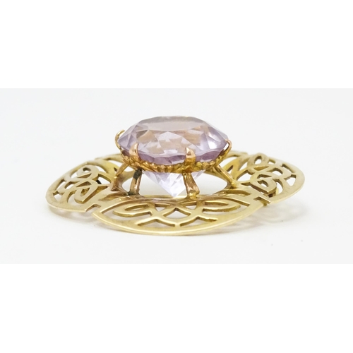 634 - A 9ct gold brooch set with central amethyst with Celtic decoration, hallmarked Birmingham 1966, 
mak... 