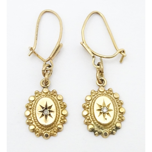 652 - A pair of 9ct gold drop earrings set with diamonds. Approx. 1