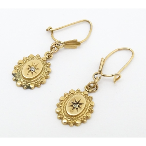 652 - A pair of 9ct gold drop earrings set with diamonds. Approx. 1