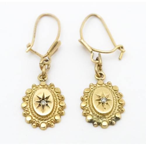 652 - A pair of 9ct gold drop earrings set with diamonds. Approx. 1