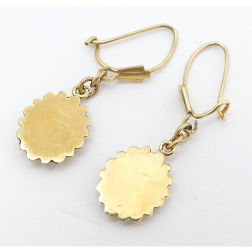 652 - A pair of 9ct gold drop earrings set with diamonds. Approx. 1