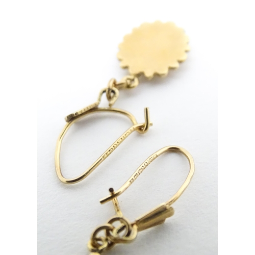 652 - A pair of 9ct gold drop earrings set with diamonds. Approx. 1