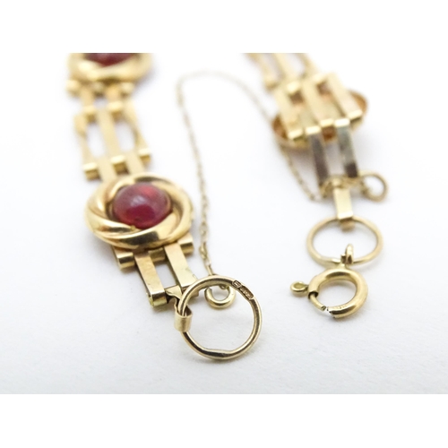 656 - A Victorian 9ct gold and yellow metal bracelet set with five garnet cabochons. Approx. 6