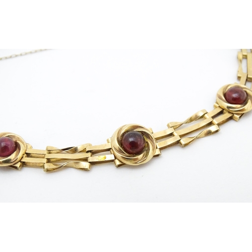 656 - A Victorian 9ct gold and yellow metal bracelet set with five garnet cabochons. Approx. 6