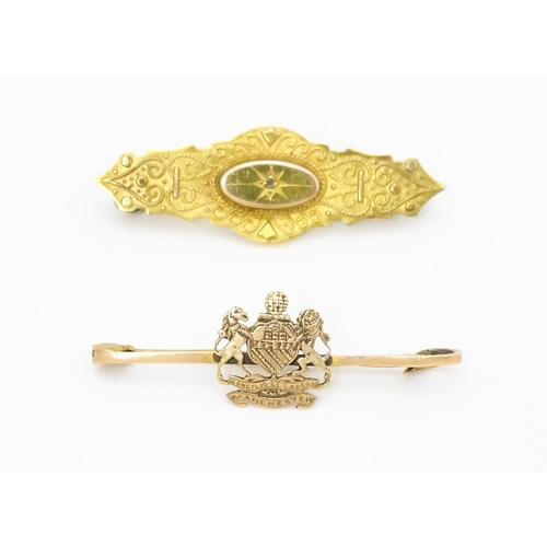 657 - Two Victorian brooches, one set with central diamond, the other with Manchester crest. Each approx. ... 