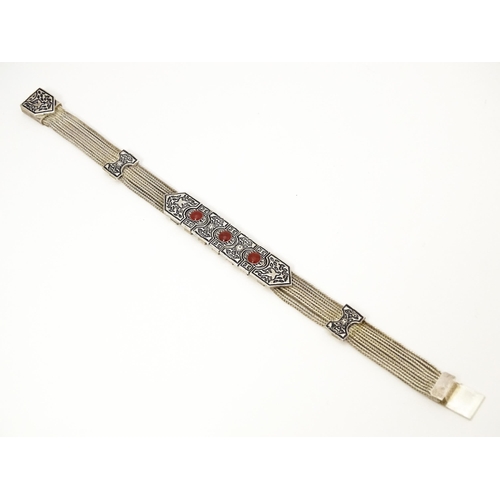 691 - A silver bracelet with five-strand detail and three carnelian coloured cabochon. Approx 7