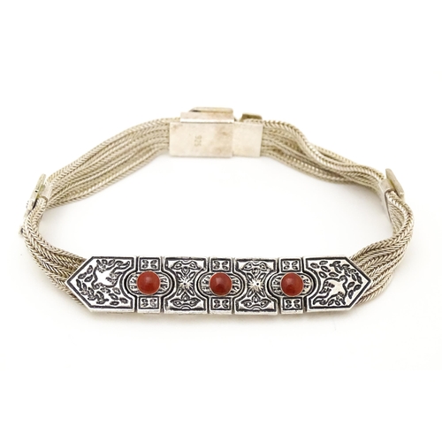 691 - A silver bracelet with five-strand detail and three carnelian coloured cabochon. Approx 7