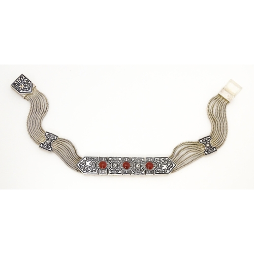 691 - A silver bracelet with five-strand detail and three carnelian coloured cabochon. Approx 7