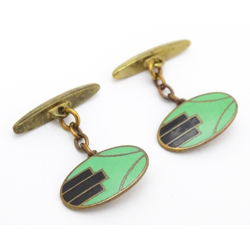 747 - A pair of gilt metal cufflinks with Art Deco enamel decoration.