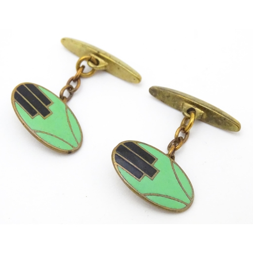 747 - A pair of gilt metal cufflinks with Art Deco enamel decoration.