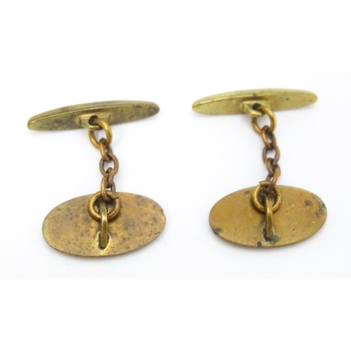 747 - A pair of gilt metal cufflinks with Art Deco enamel decoration.