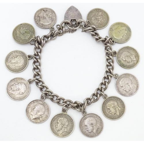 760 - A silver bracelet set with various George V and Edward VI coins