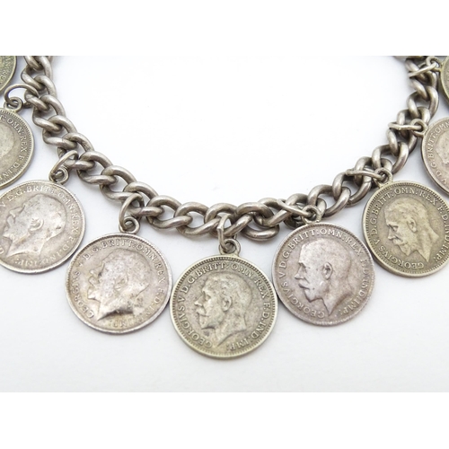 760 - A silver bracelet set with various George V and Edward VI coins