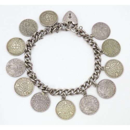 760 - A silver bracelet set with various George V and Edward VI coins