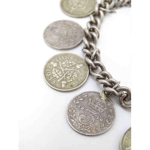 760 - A silver bracelet set with various George V and Edward VI coins