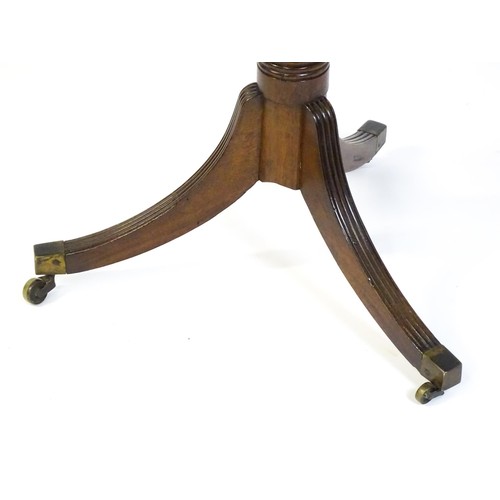 1432 - A late Georgian mahogany tripod table with a carved pie crust style top, a coil style turned pedesta... 