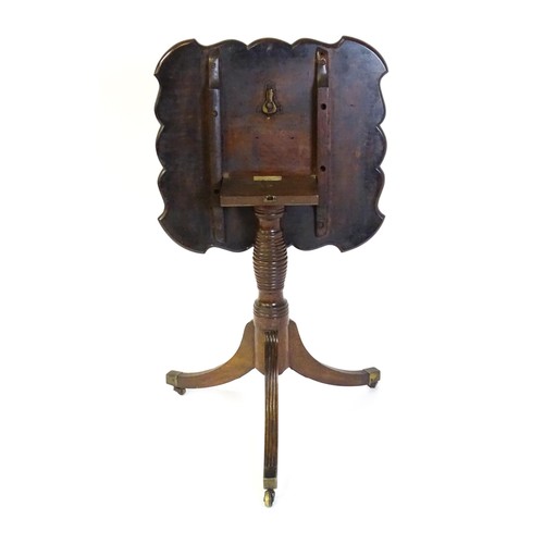 1432 - A late Georgian mahogany tripod table with a carved pie crust style top, a coil style turned pedesta... 