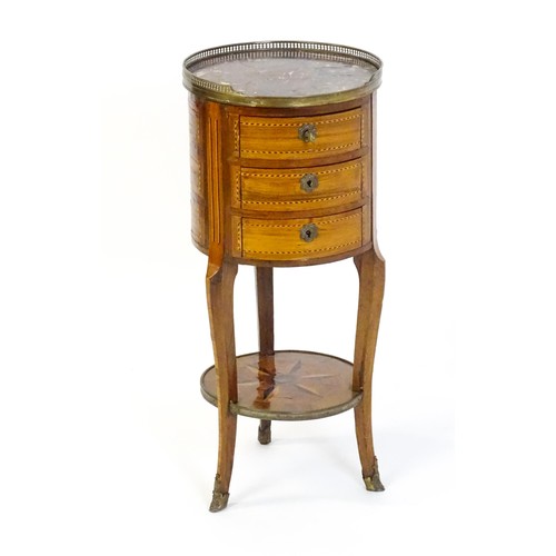 1437 - An early 20thC marble topped side table, with a pierced brass upstand above three short drawers with... 